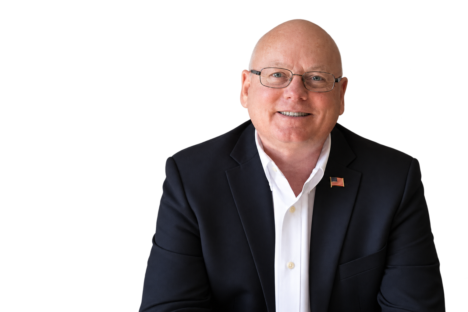 Carl Boyanton smiling, wearing glasses and a dark blazer